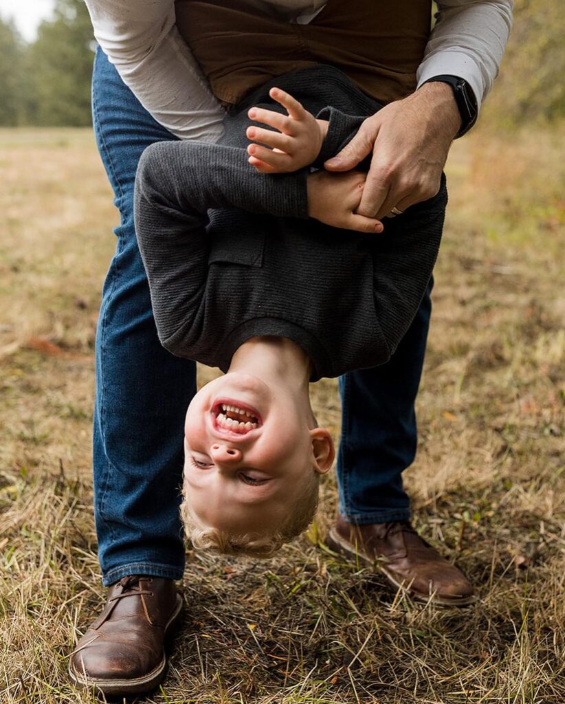 Little boy laughing at his family portrait session with Jenny Kang Photography