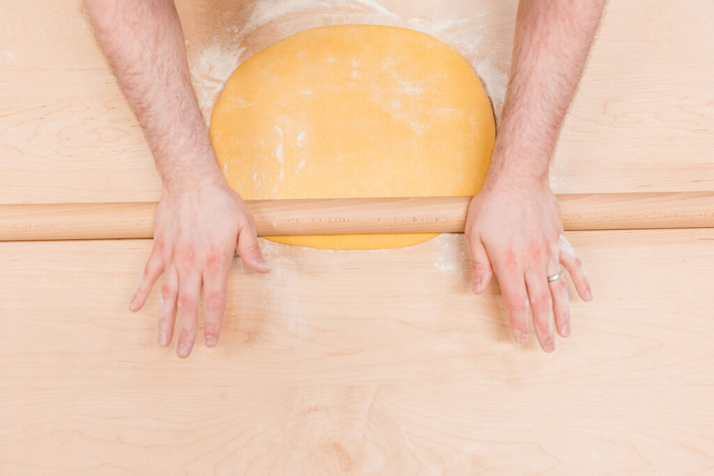 Hands rolling pasta dough at Pastificio d'Oro in Portland, OR - photo by Jenny Kang Photography